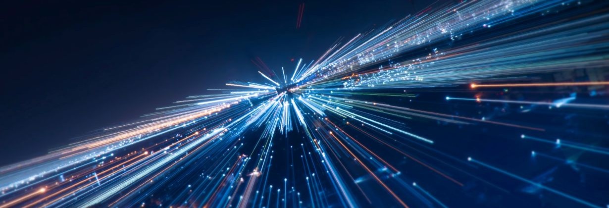 Abstract blue and white light trails converging at high speed